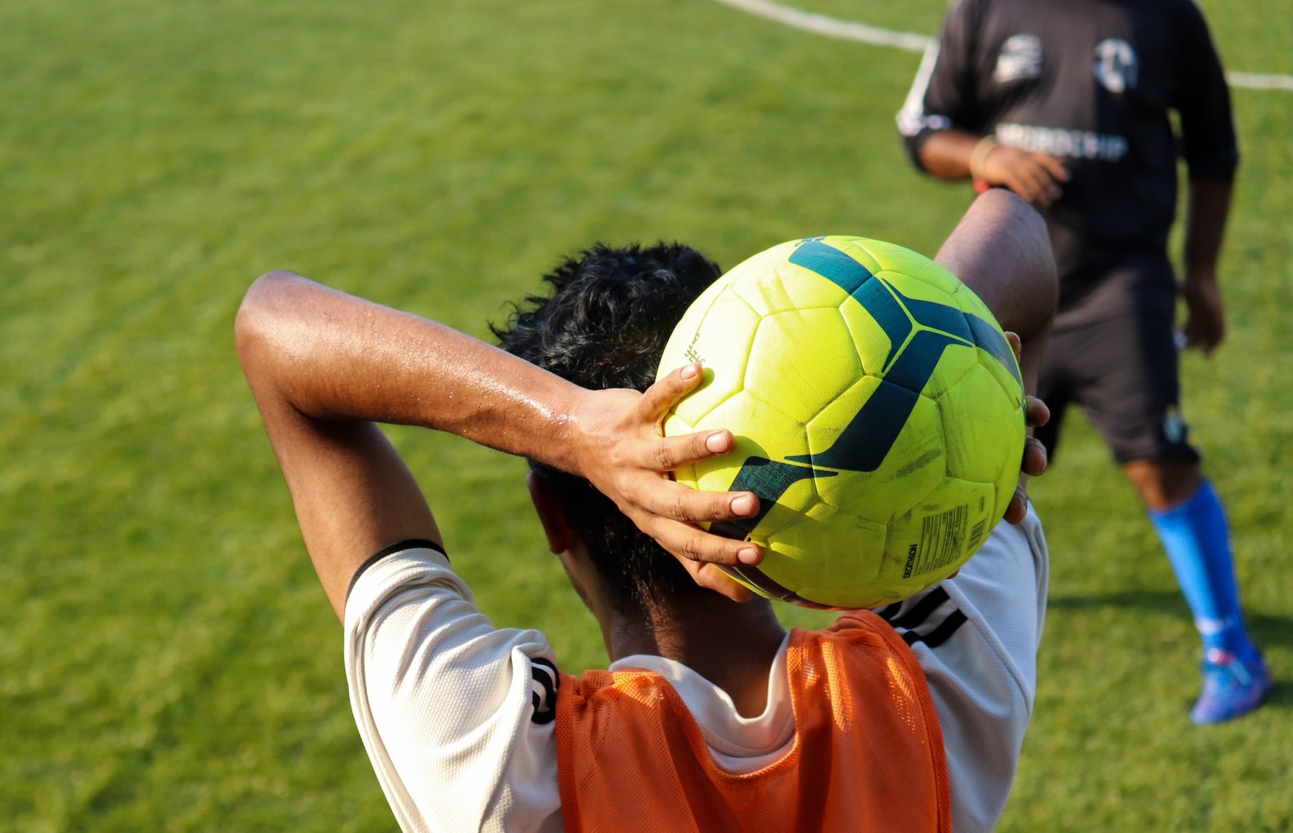 Soccer Player throwing in the ball.